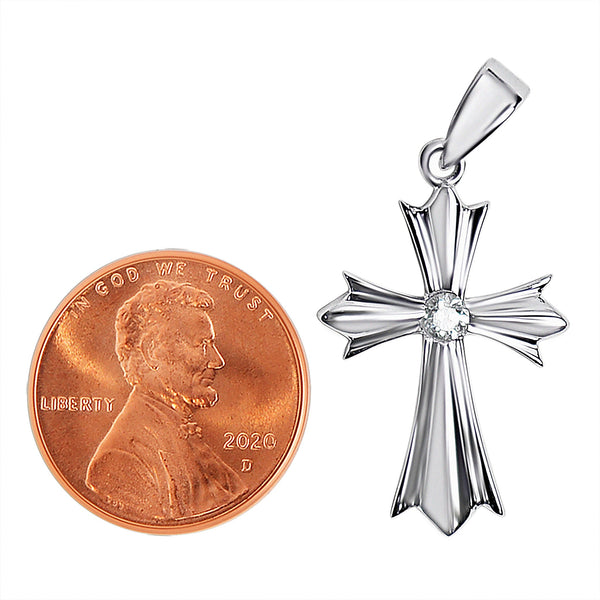 Sterling silver Cross with a Cubic Zirconia center pendant with a penny for scale.