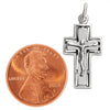 Sterling silver Crucifix Cross pendant with a penny for scale.