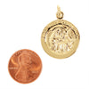 Sterling silver 18K gold PVD Coated "First Holy Communion" pendant with a penny for scale.