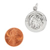 Sterling silver "First Holy Communion" pendant with a penny for scale.