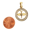 Sterling silver 18K gold PVD Coated Cubic Zirconia circled dove pendant with a penny for scale.