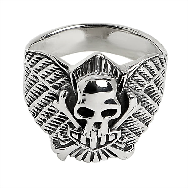 Sterling silver winged skull and crossbones shield ring at an angle.