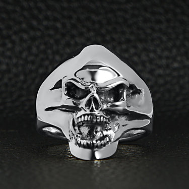 Sterling silver screaming skull ring on a black leather background.