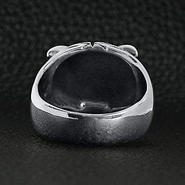 Sterling silver red Cubic Zirconia eyed tiger ring back view on a black leather background.