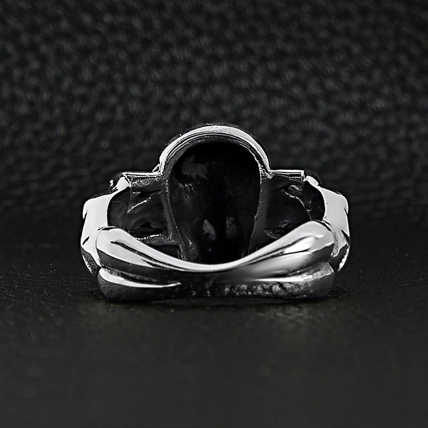 Sterling silver skull and nude women ring back view on a black leather background.