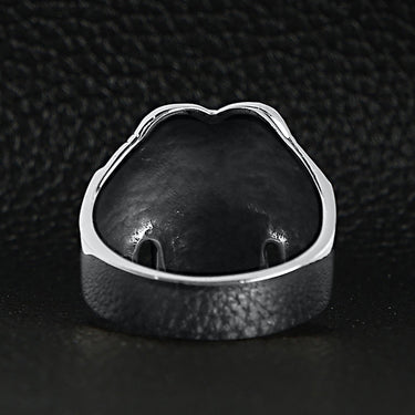 Sterling silver pilot skull ring back view on a black leather background.