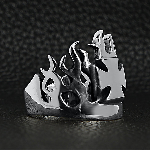 Sterling silver Maltese Cross flame ring angled on a black leather background.