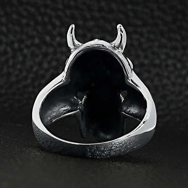 Sterling silver devil skull ring back view on a black leather background.