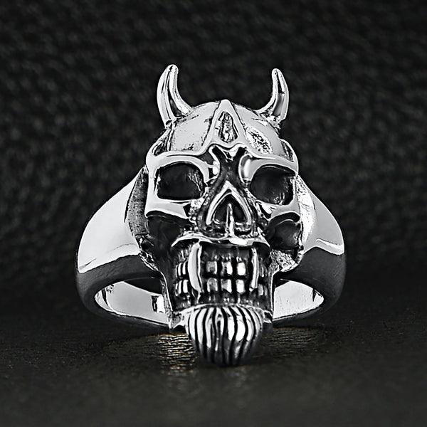Sterling silver devil skull ring on a black leather background.