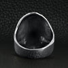 Sterling silver flaming skull ring back view on a black leather background.