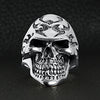 Sterling silver flaming skull ring on a black leather background.