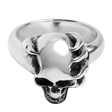Sterling silver skull in demon hand ring angled down.