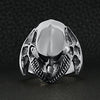 Sterling silver alien skull ring on a black leather background.