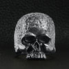 Sterling silver hammered texture skull ring on a black leather background.