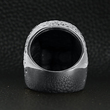 Sterling silver hammered texture skull ring back view on a black leather background.