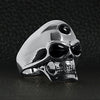 Sterling silver black eyed skull with 3rd eye ring angled on a black leather background.